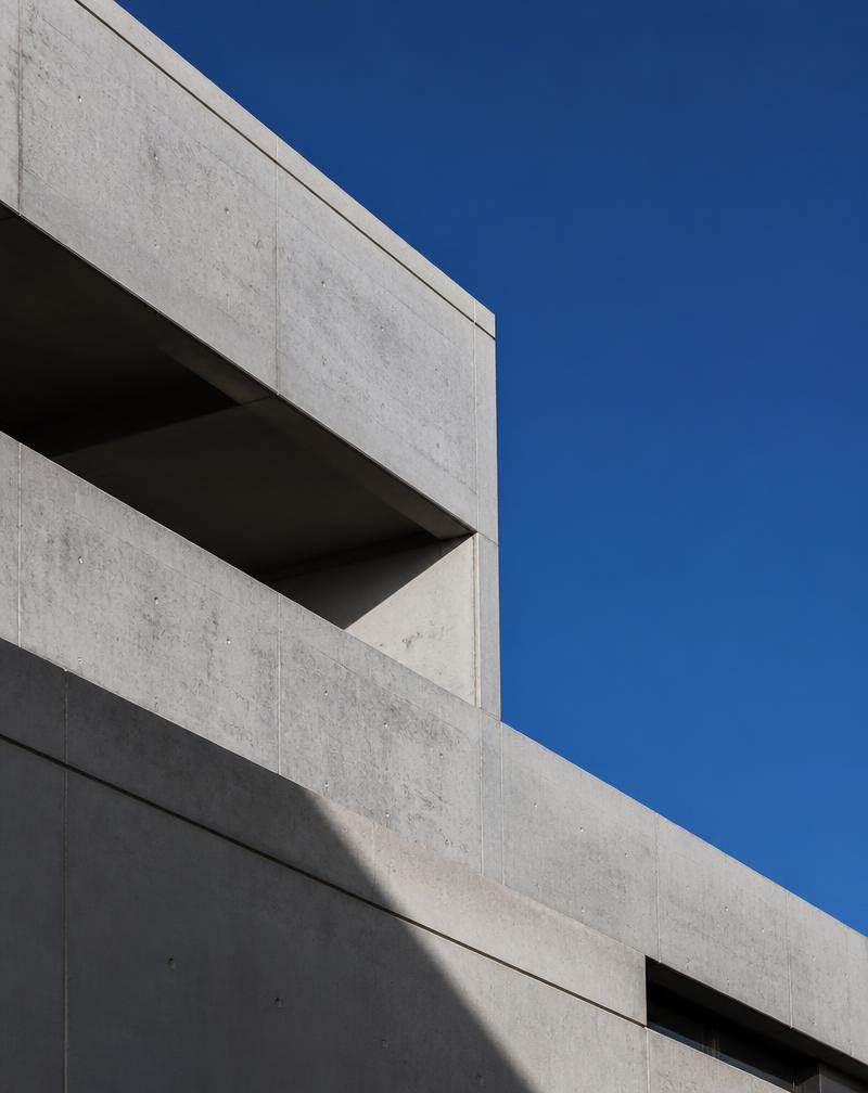 Brutalist concrete architecture against a deep blue sky
